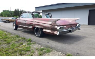 Cadillac-Deville-1961-pompian-red-whiteburgundy-2